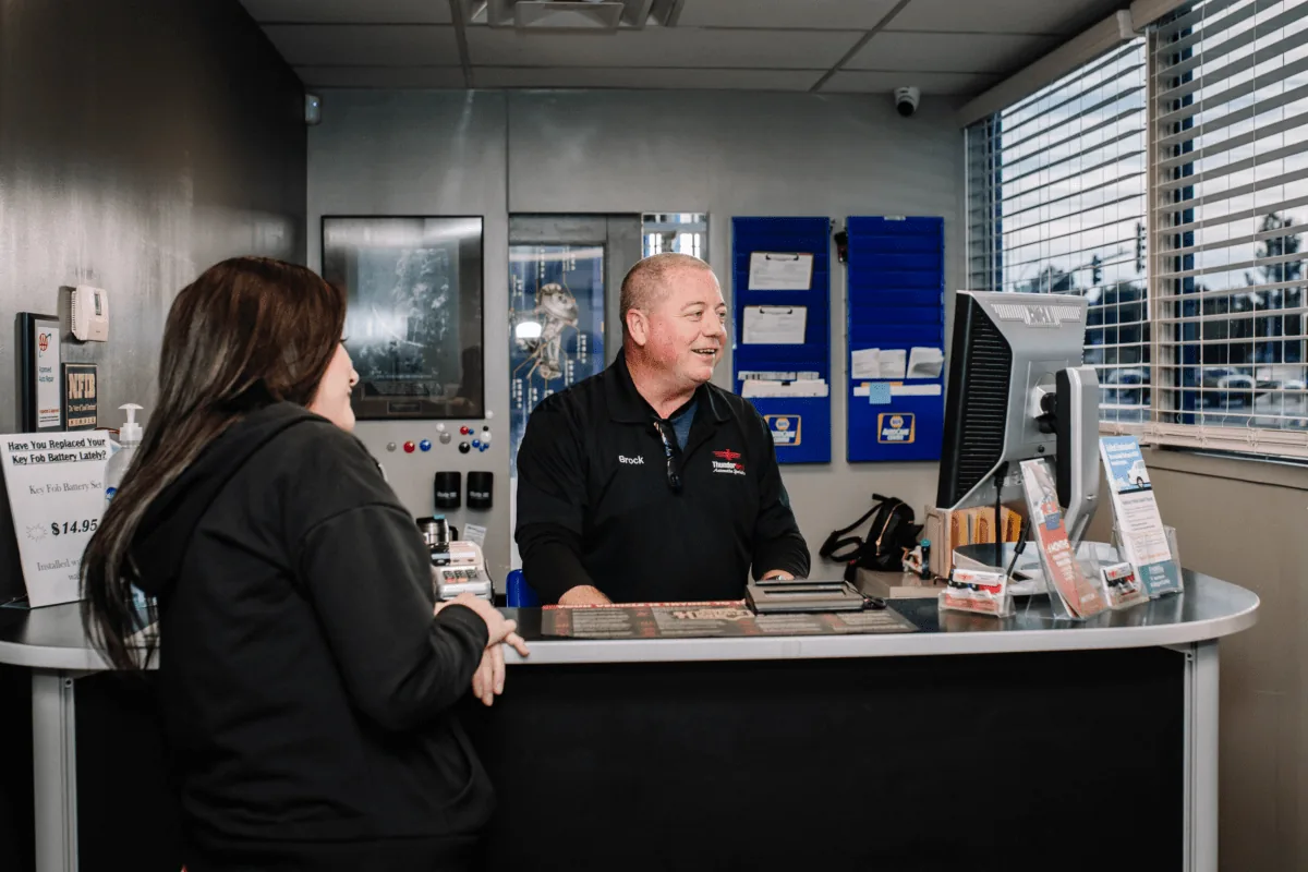 Thunderbird Automotive Specialists service counter with staff helping a customer